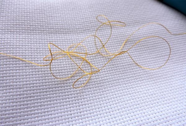 Embroidering a pair of golden lions